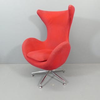 A red upholstered egg chair in the manner of Arne Jacobsen f...