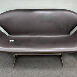 In the manner of Arne Jacobsen, a dark brown leather and chr...