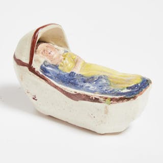 English Prattware Pottery Model of a Baby in a Cradle, early 19th century -